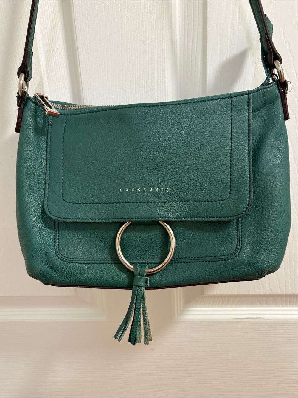 dark green textured leather Sanctuary crossbody bag with a front flap